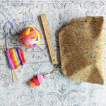 cork speckled project bag with colourful tassel and self striping yarn for socks