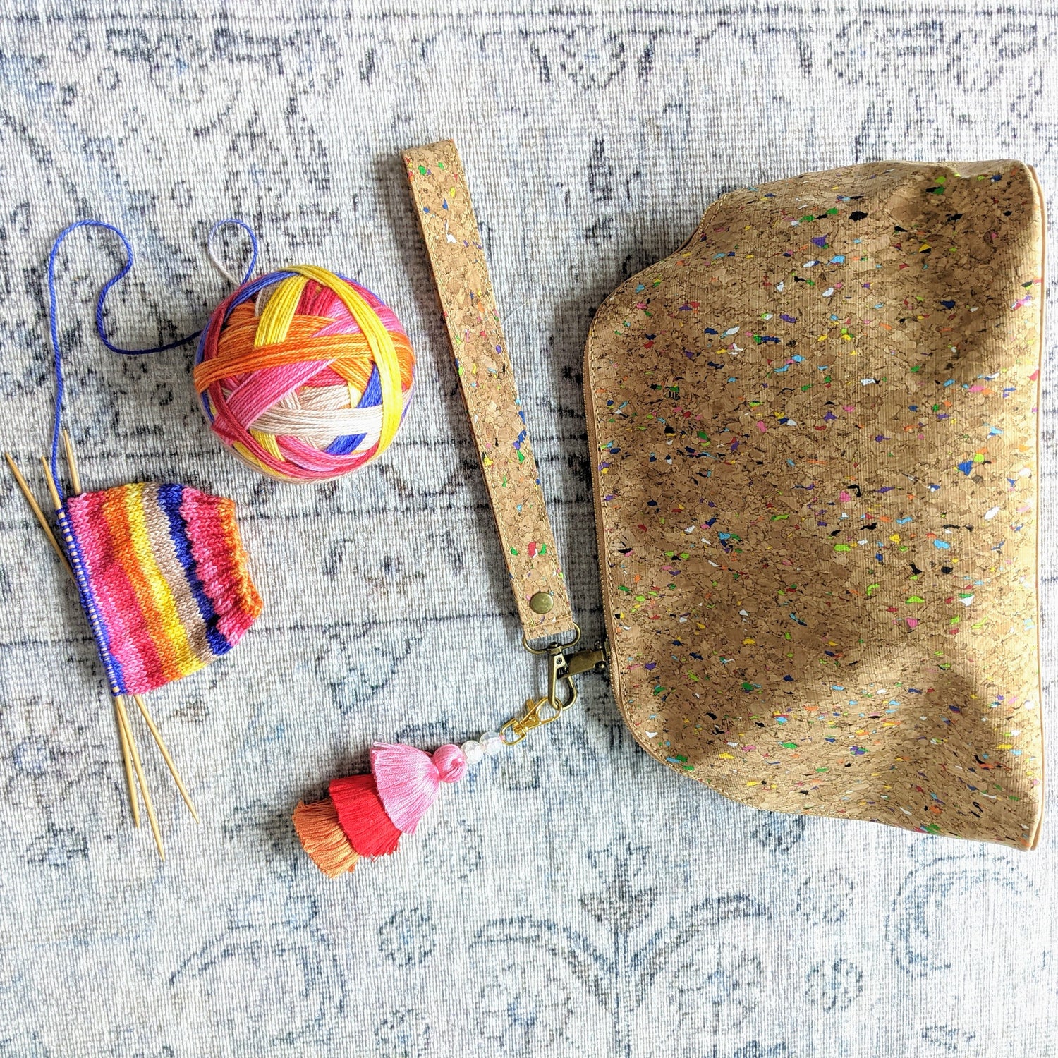 cork speckled project bag with colourful tassel and self striping yarn for socks